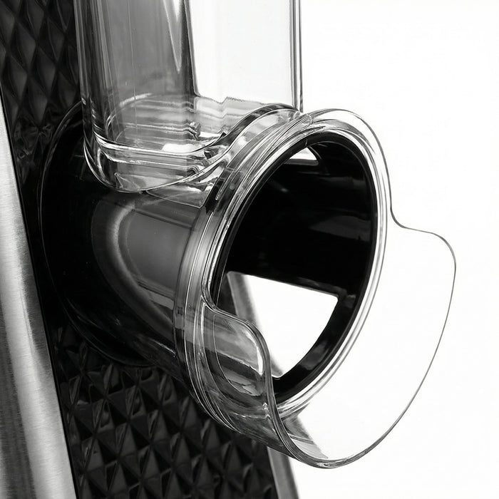 Close-up of a clear plastic cup with a metal rim on a textured black surface.