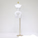 White mannequin torso on a brass stand against a white background