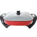 Red electric skillet with a glass lid on a white background