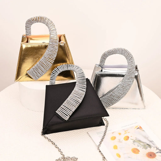 Three handbags with decorative handles on a light background