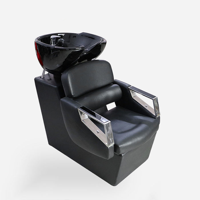 Black salon shampoo chair with bowl on a white background