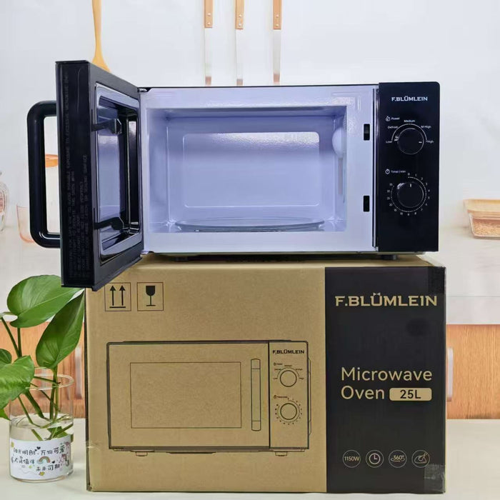 F. Blümlein microwave oven shown open, resting on top of its cardboard packaging box.