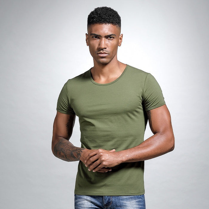 Man wearing a green t-shirt against a gray background