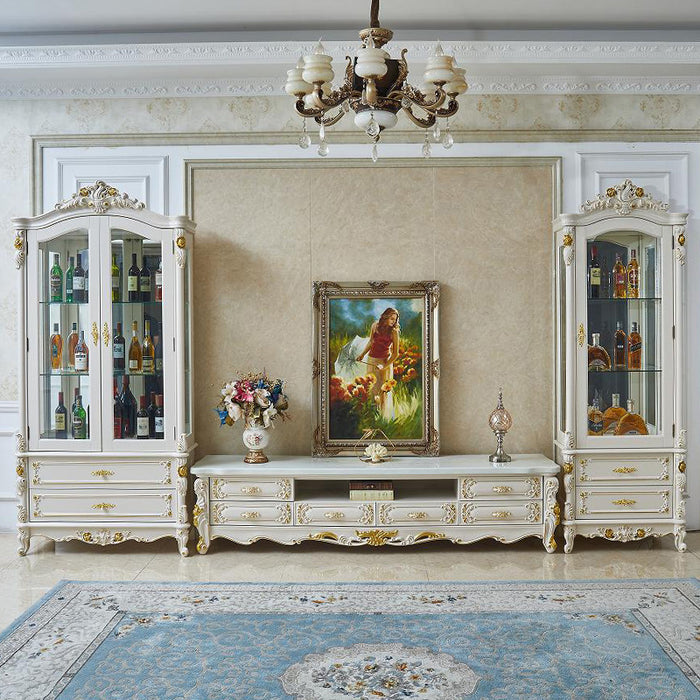 Luxurious living room with ornate white furniture, decorative painting, and chandelier.