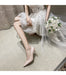 Bride in a white dress with a bouquet sitting on the floor.
