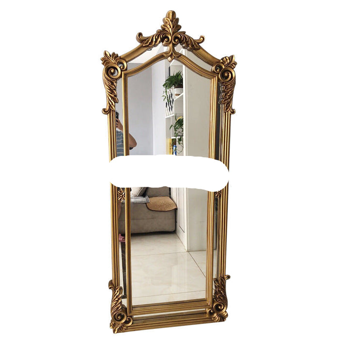Decorative gold-framed mirror on a white background