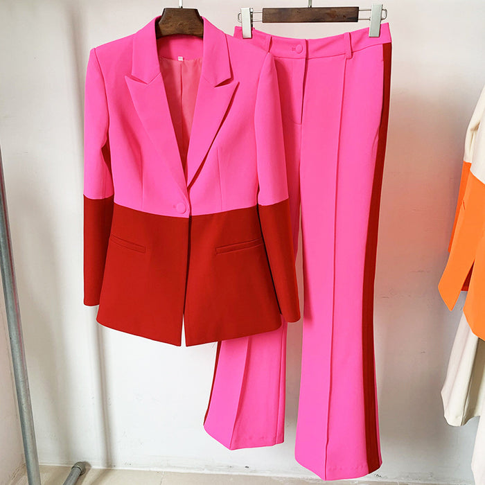 Two-tone pink and red suit on hangers against a white background