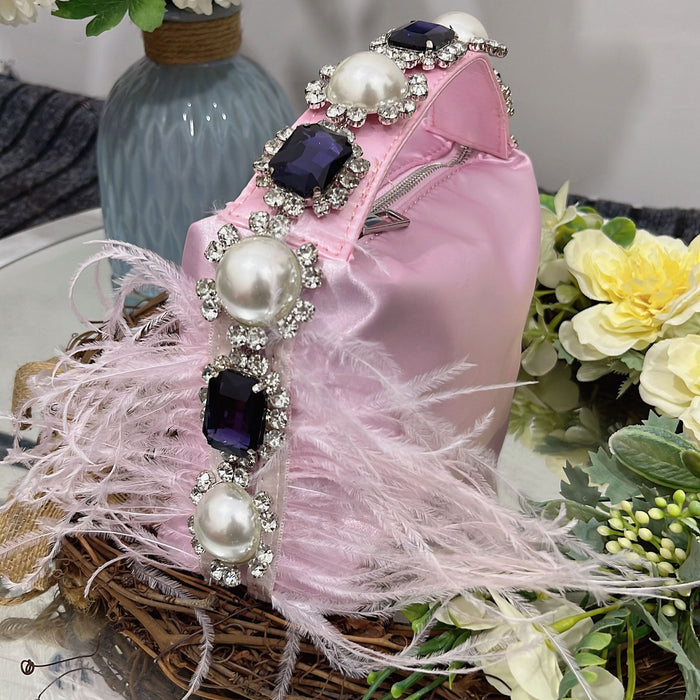 Pink handbag with decorative elements on a surface with flowers and a vase in the background