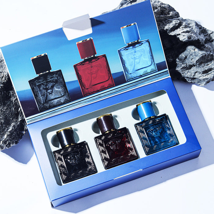 Set of six perfume bottles in a blue box with a scenic background