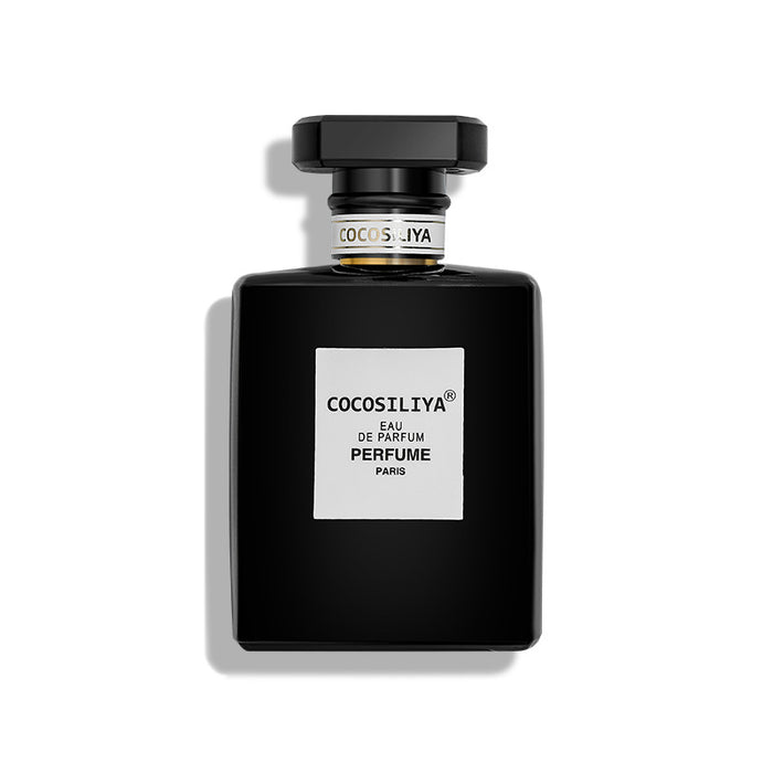 Black perfume bottle with white label on a white background