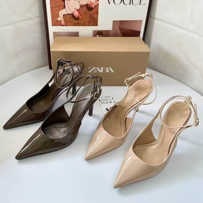 Pair of brown high-heeled shoes with a beige shoe and Zara box in the background.