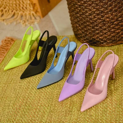Set of colorful high-heeled shoes on a textured surface