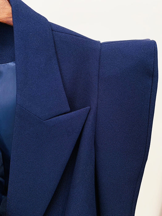 Close-up of a blue blazer with a white background