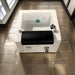 White sink with black basin on a tiled floor