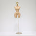 Mannequin torso on a stand with a gold head against a white background