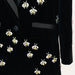 Black blazer with bee-shaped embellishments on a white background