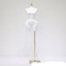White mannequin torso on a gold stand against a white background