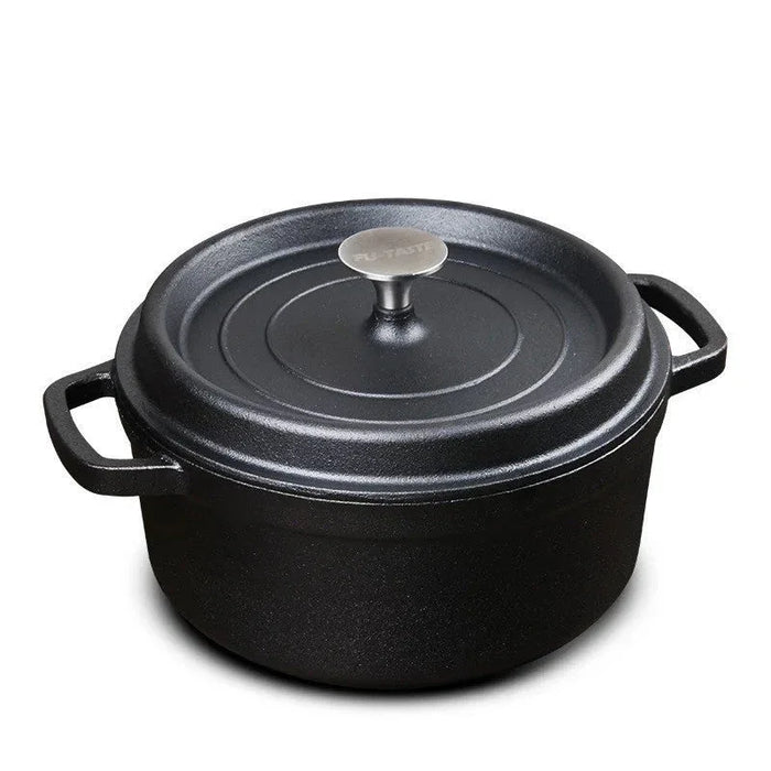 Black cast iron pot with lid on a white background
