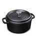 Black cast iron pot with lid on a white background