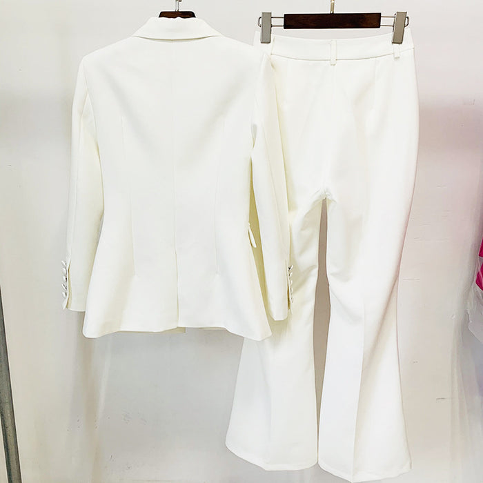 White suit jacket and pants on hangers against a white background