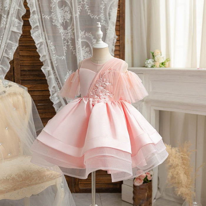 Pink dress on a mannequin against a decorative background