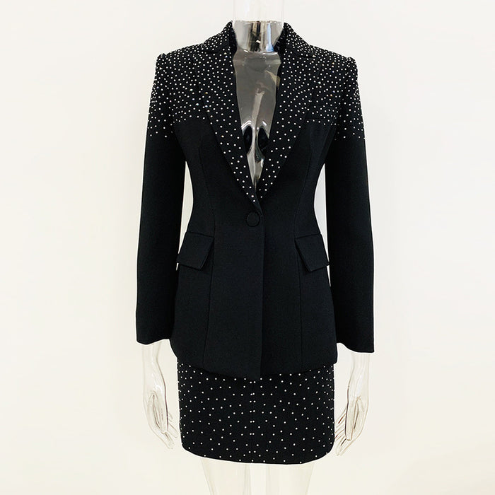 Black blazer with white polka dot trim on a mannequin against a white background
