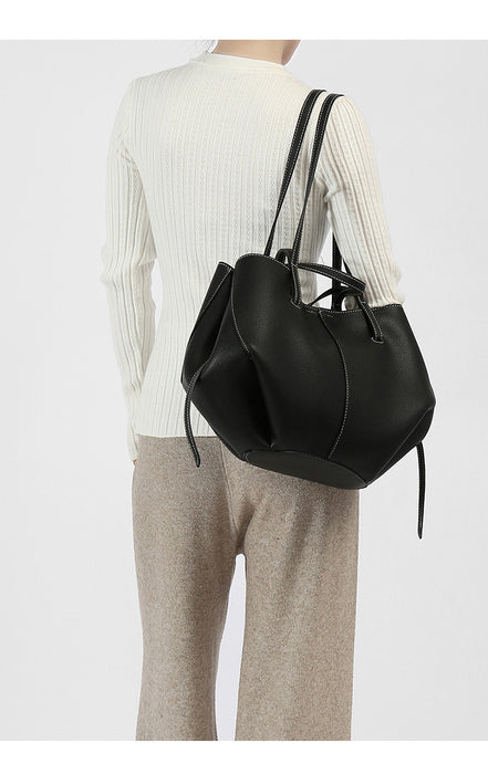 Person wearing a black backpack on a white background