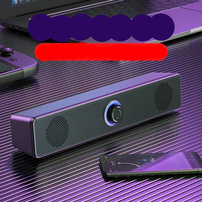 Black speaker bar on a reflective surface with a purple and red blurred area