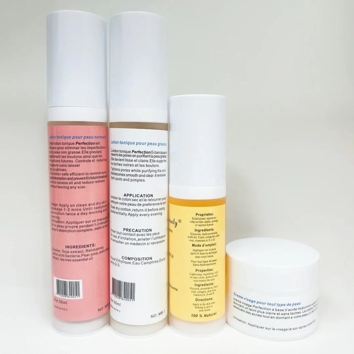 Four skincare product bottles with labels on a white background
