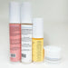 Four skincare product bottles with labels on a white background