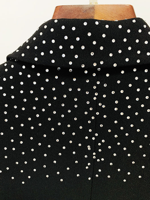 Black fabric with white polka dots on a wooden surface