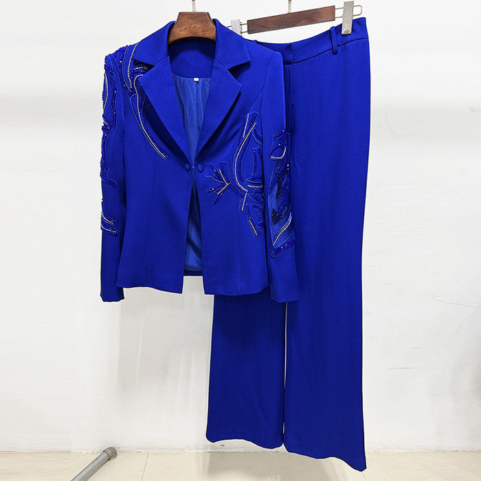 Blue suit with jacket and pants on a hanger against a white background