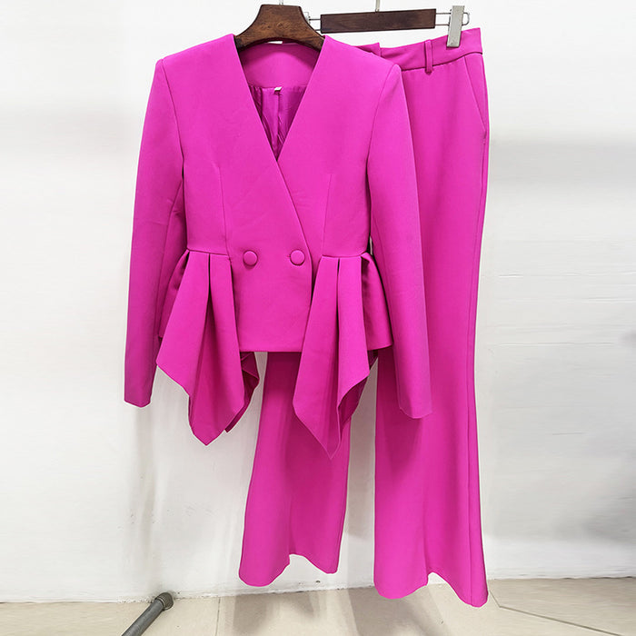 Pink suit with a blazer and pants on a hanger against a white background