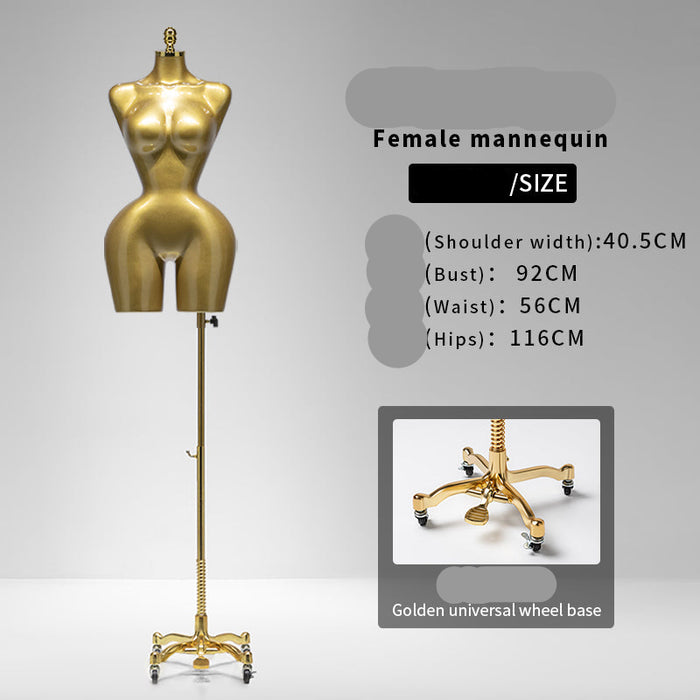 Gold female mannequin with wheels on a gray background