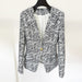 Black and white patterned blazer on a hanger against a white background