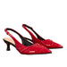 A pair of red patent leather slingback pumps with a pointed toe and a low kitten heel, shown against a plain white background.