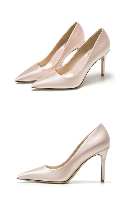 Pair of pink high-heeled shoes on a white background