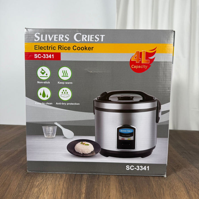 Slivers Priest electric rice cooker packaging on a wooden surface with a white curtain background