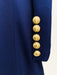 Close-up of a navy blue jacket with gold buttons on a white background