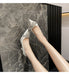 White high-heeled shoes with embellishments on a marble floor