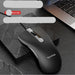 Black computer mouse with ViewSonic branding on a textured surface, with a laptop in the background.