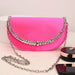 Pink handbag with silver chain on a white surface