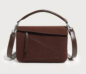 Brown handbag with a strap on a light gray background