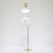White mannequin torso on a gold stand against a white background
