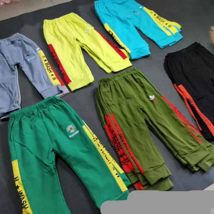 Colorful pants with text and logos on a dark surface