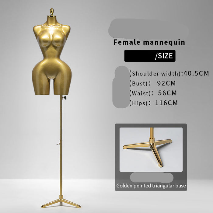 Gold female mannequin with stand on a gray background
