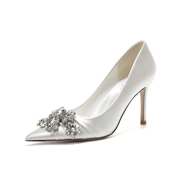 White high-heeled shoe with a decorative crystal embellishment on a white background