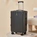 Black suitcase on a beige background