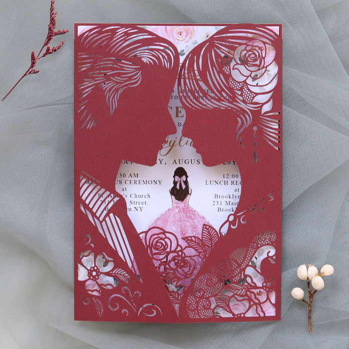 Decorative wedding invitation with intricate cut-out designs on a gray background