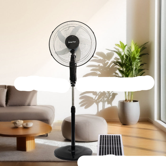 Black standing fan in a living room with a plant and furniture.